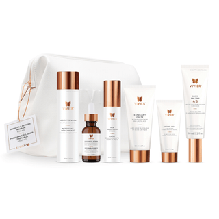 A collection of VIVIER products including a Medicated Wash, Radiance Serum, Skin Brightening Cream, Exfoliant Forte, 1% Retinol, and Sheer SPF 45, neatly arranged with in white VIVIER cosmetic bag with a rose gold zipper.